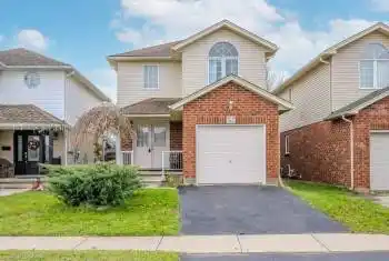 Front facade featuring a front yard and a garage